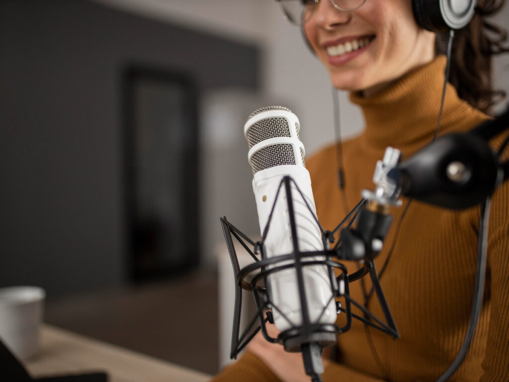 Best storytelling podcasts list - a young woman behind a mic.